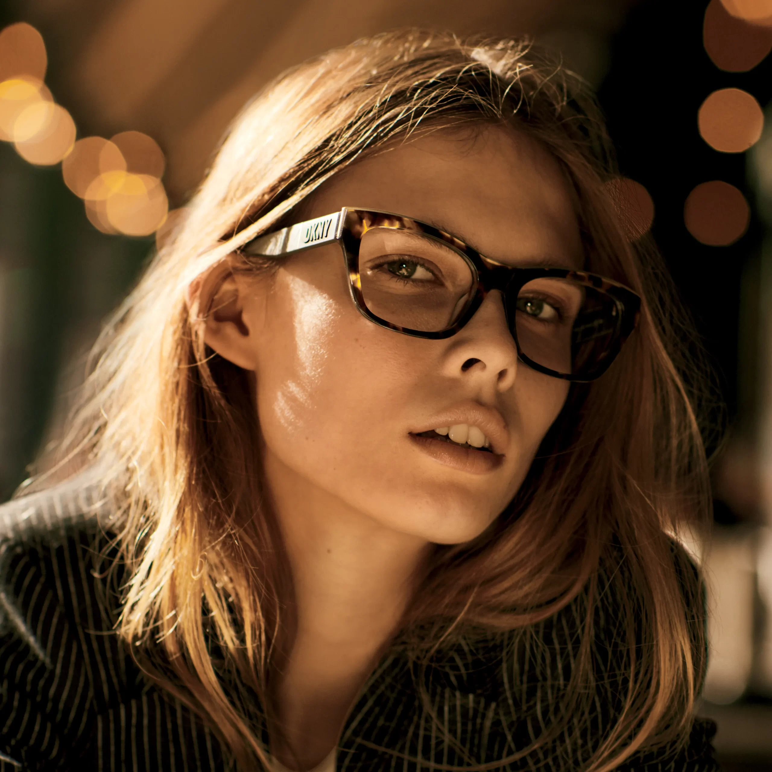 A model wearing DKNY glasses