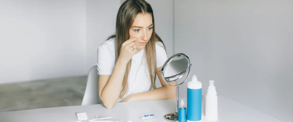 Girl staring in front of the mirror.