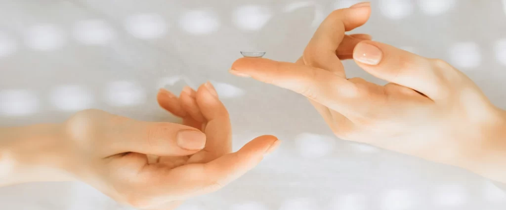 Contact lens is placed on the index finger