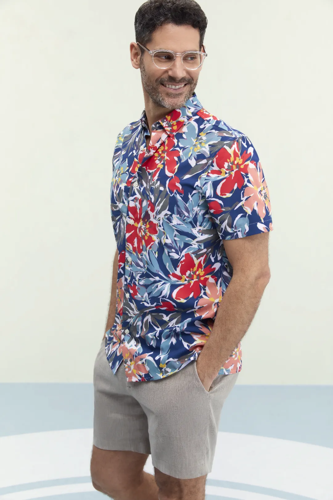 man wearing a floral shirt and perry elis eyeglasses