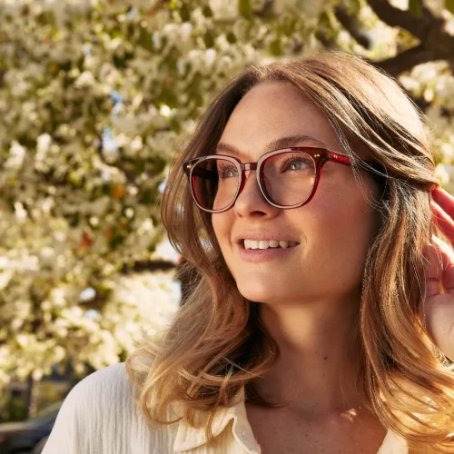 woman wearing toms eyeglasses in a red frame